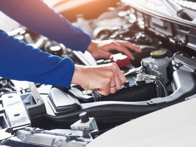 hands-of-car-mechanic-with-wrench-in-garage-KA3UEHD.jpg